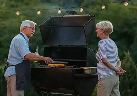 Couple by the grill enjoying their retirement