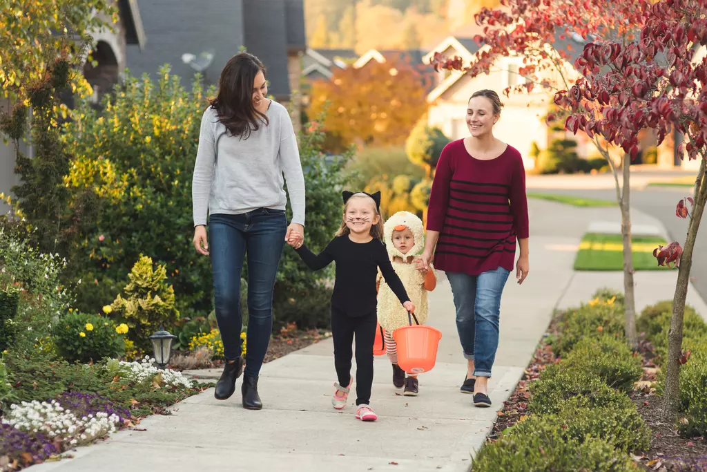 Children trick or treating with their parents