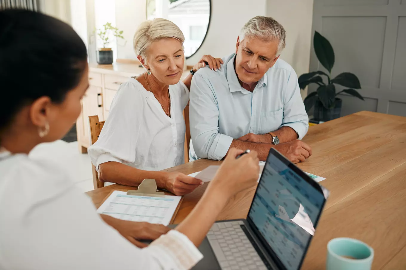 Couple reviewing paper work with advisor 